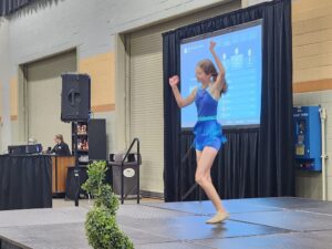 Madie Deutmeyer performing at the conference.