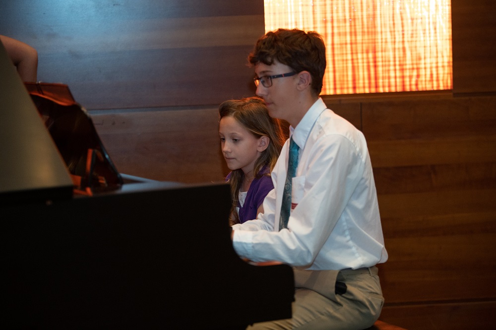 Youth playing piano at the 2023 NACAA conference in Des Moines.